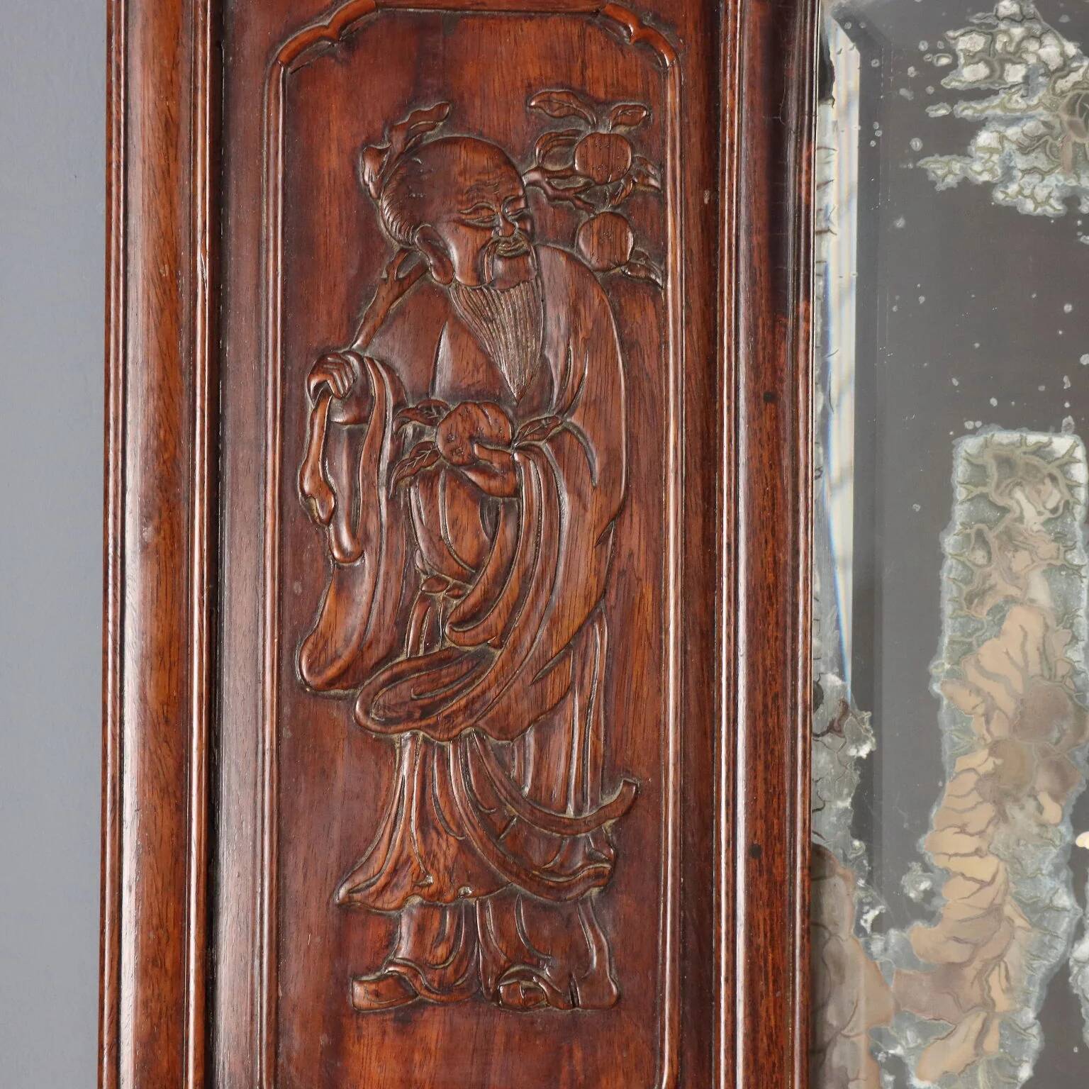 Antique mirror in exotic wood with chinoiserie carvings, 19th century.