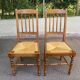 Solid wood chair with a straw seat and carved bar backrest.