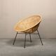 Round rattan lounge chair with black metal frame
