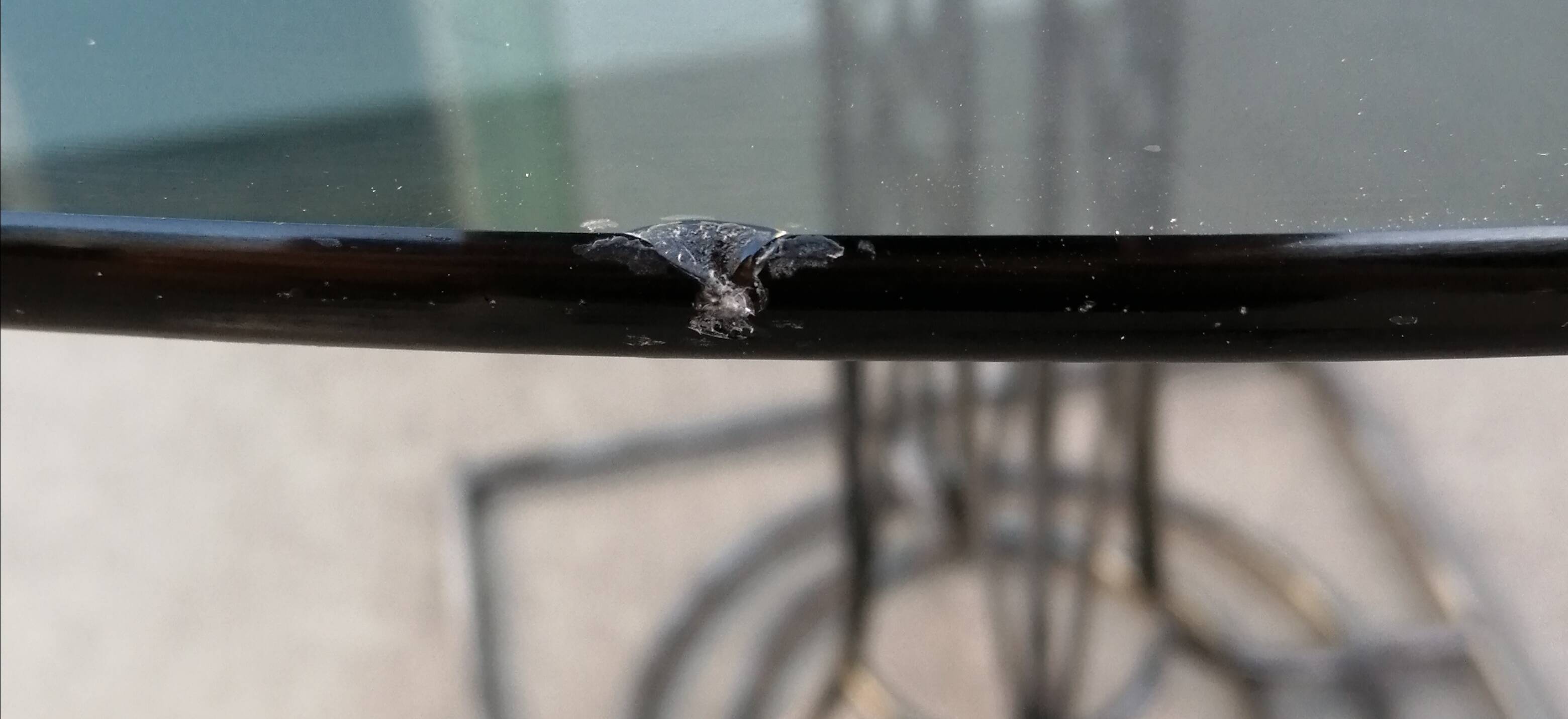 Wrought iron dining table with its round smoked glass top, vintage 1980