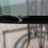 Wrought iron dining table with its round smoked glass top, vintage 1980