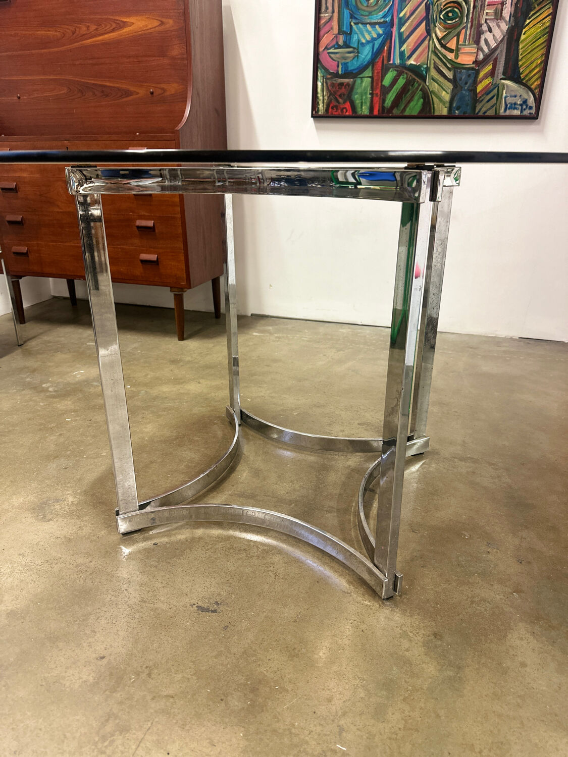 Dining table in chrome metal and smoked glass.