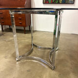 Dining table in chrome metal and smoked glass.