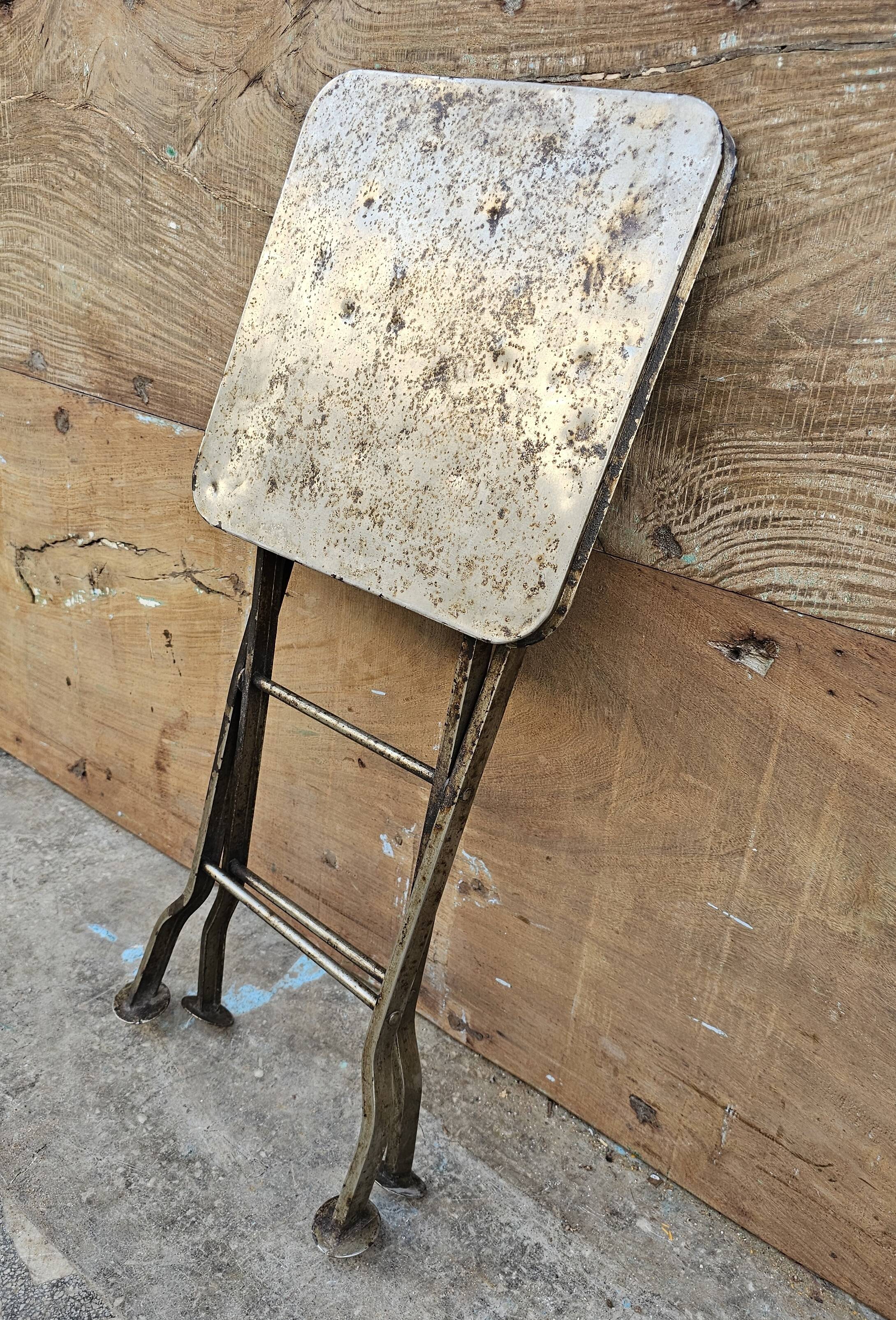 Old industrial folding steel stool
