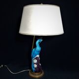 Large table lamp with earthenware peacock and beige silk lampshade