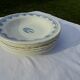 8 assiettes creuses en faïence F J avec frise et bouquet central