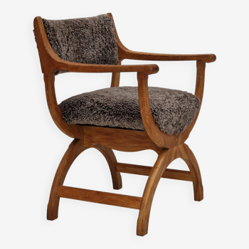 1960s, Danish design by Henning Kjærnulf, chair model "Kurul", sheepskin, oak wood.