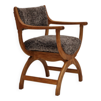 1960s, Danish design by Henning Kjærnulf, chair model "Kurul", sheepskin, oak wood.