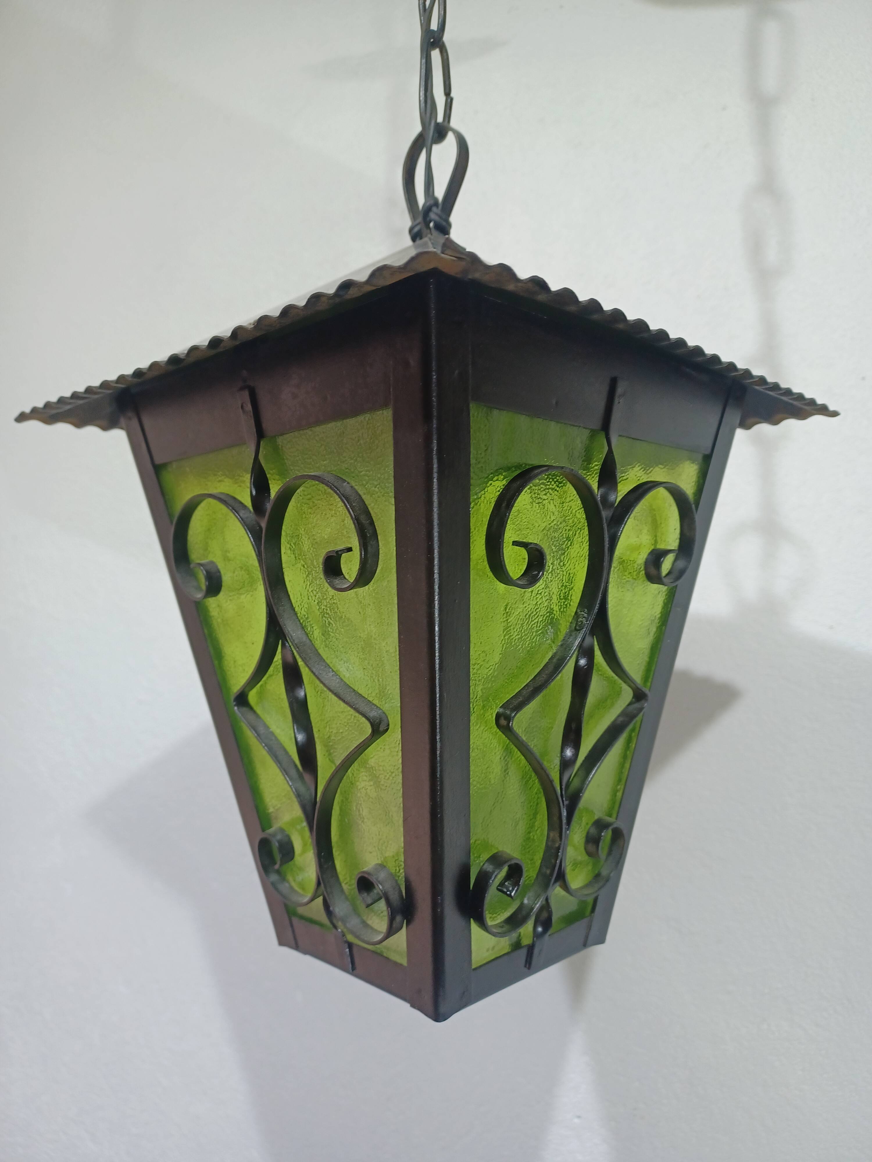 Wrought iron and green glass lantern
