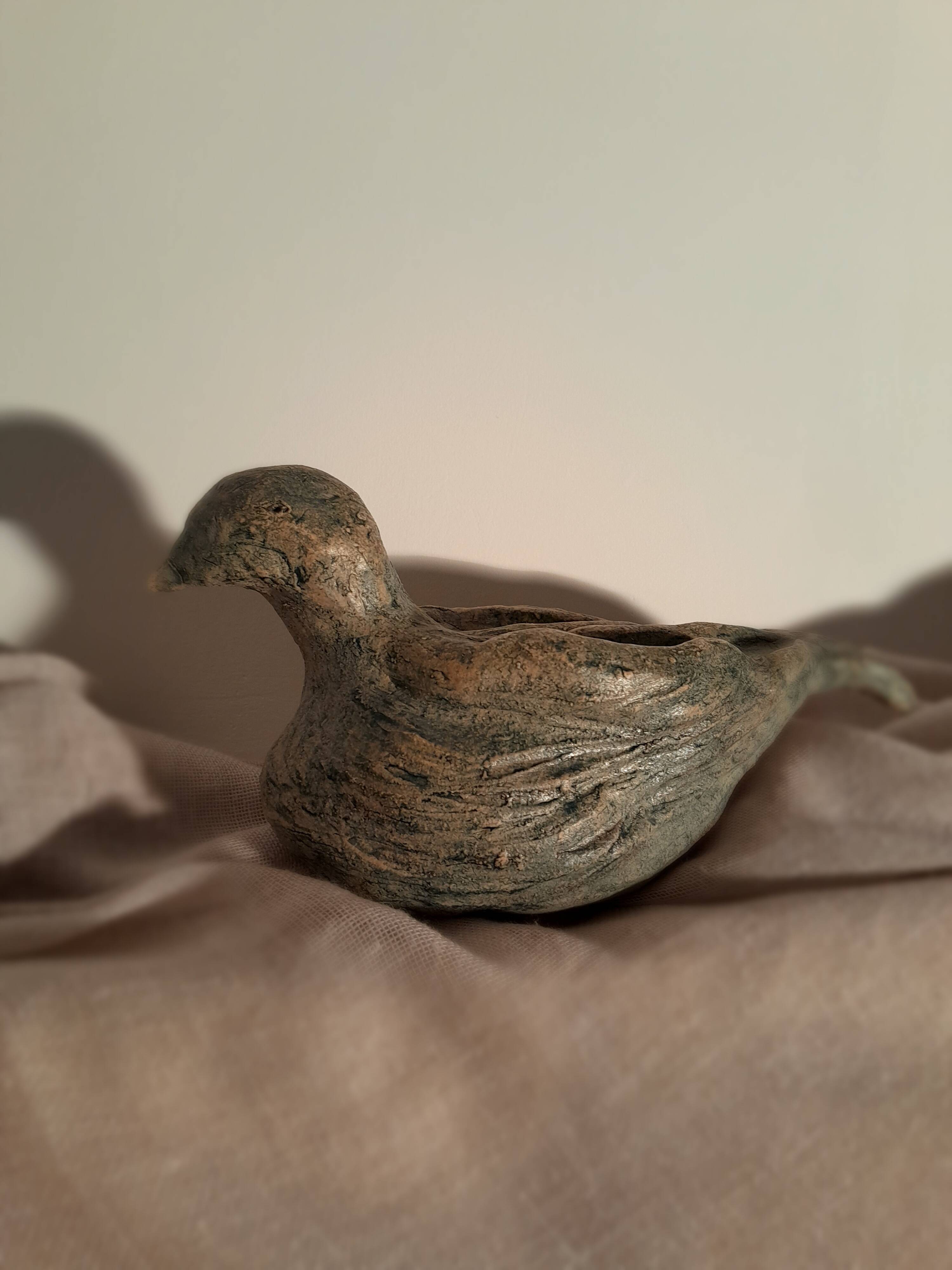 Signed bird sculpture