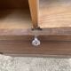 Oak two-column filing cabinet with curtains.