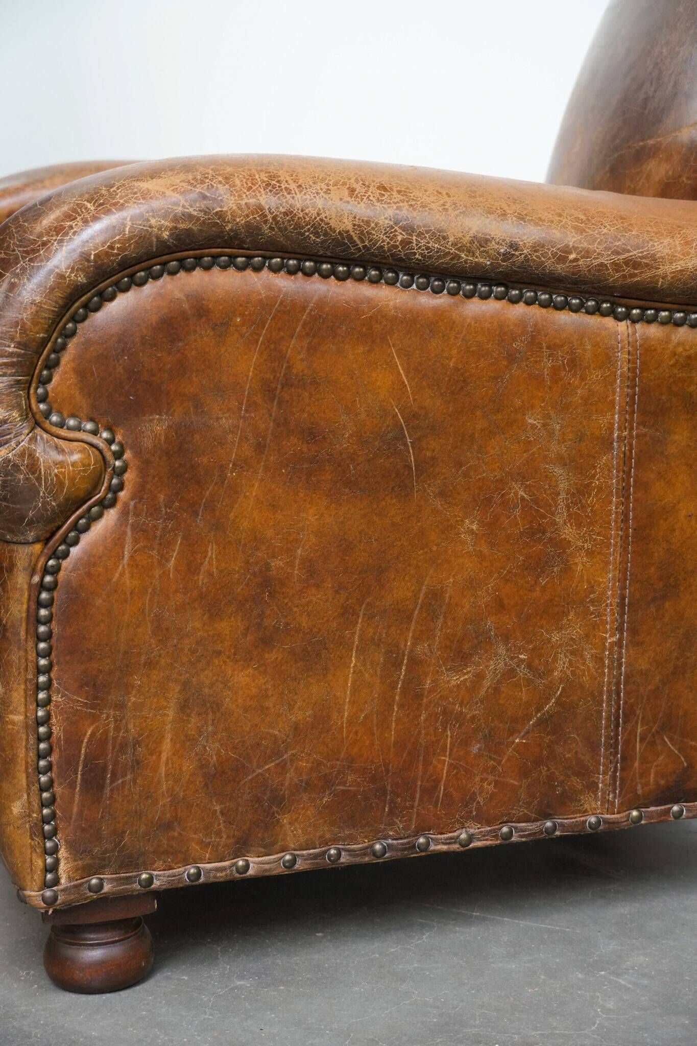 Charming and comfortable vintage armchair in grained cowhide leather with character
