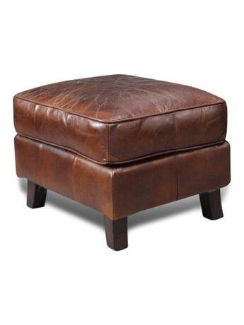 Brown leather club chair with its pouffe.
