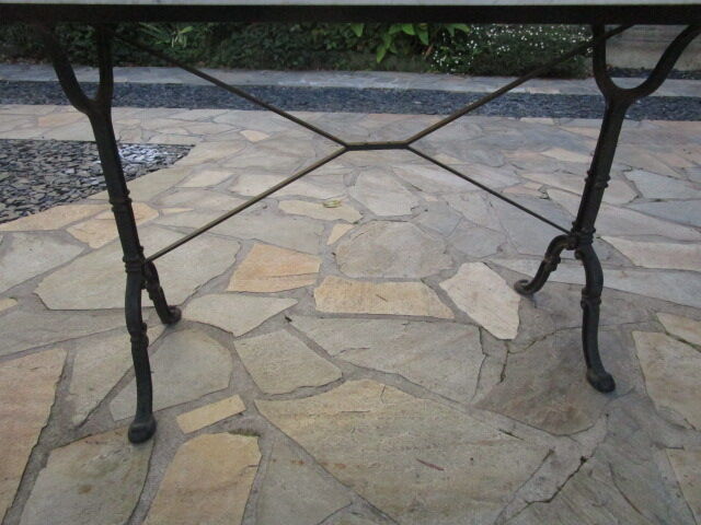 Old bistro table in marble and godin cast iron foot