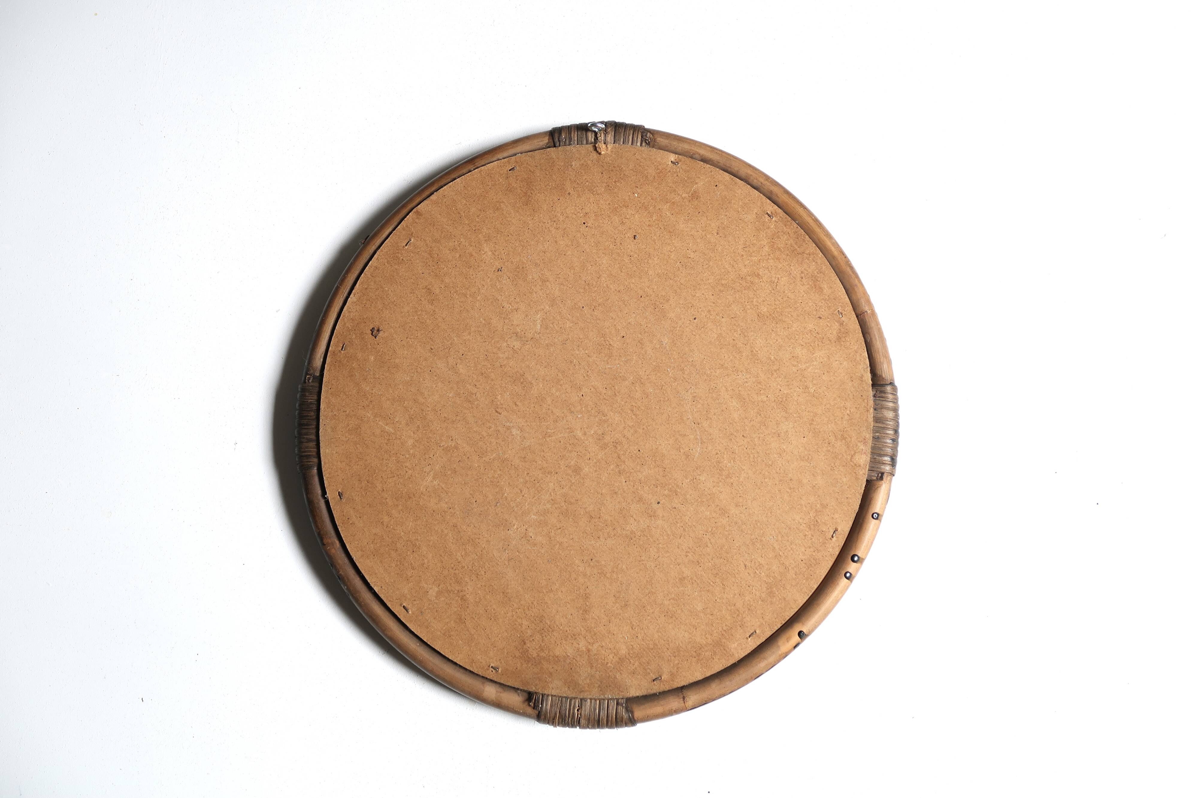 Round mirror in dark rattan, 50s