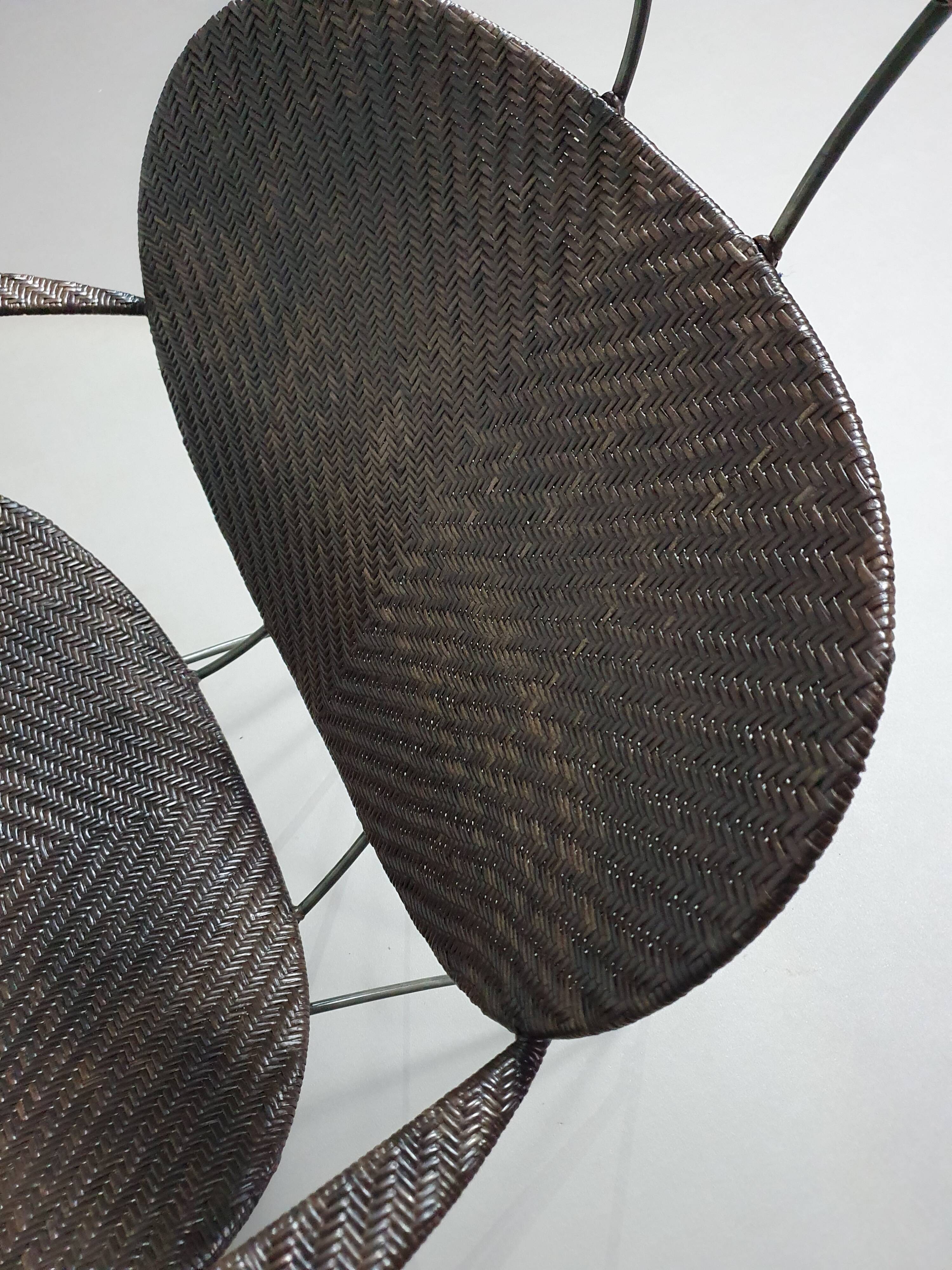 Armchair designed by Yuzuru Yamakawa  Metal frame.  Seat and back in braided rattan.