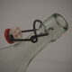 Bottle with mechanical closure in white glass