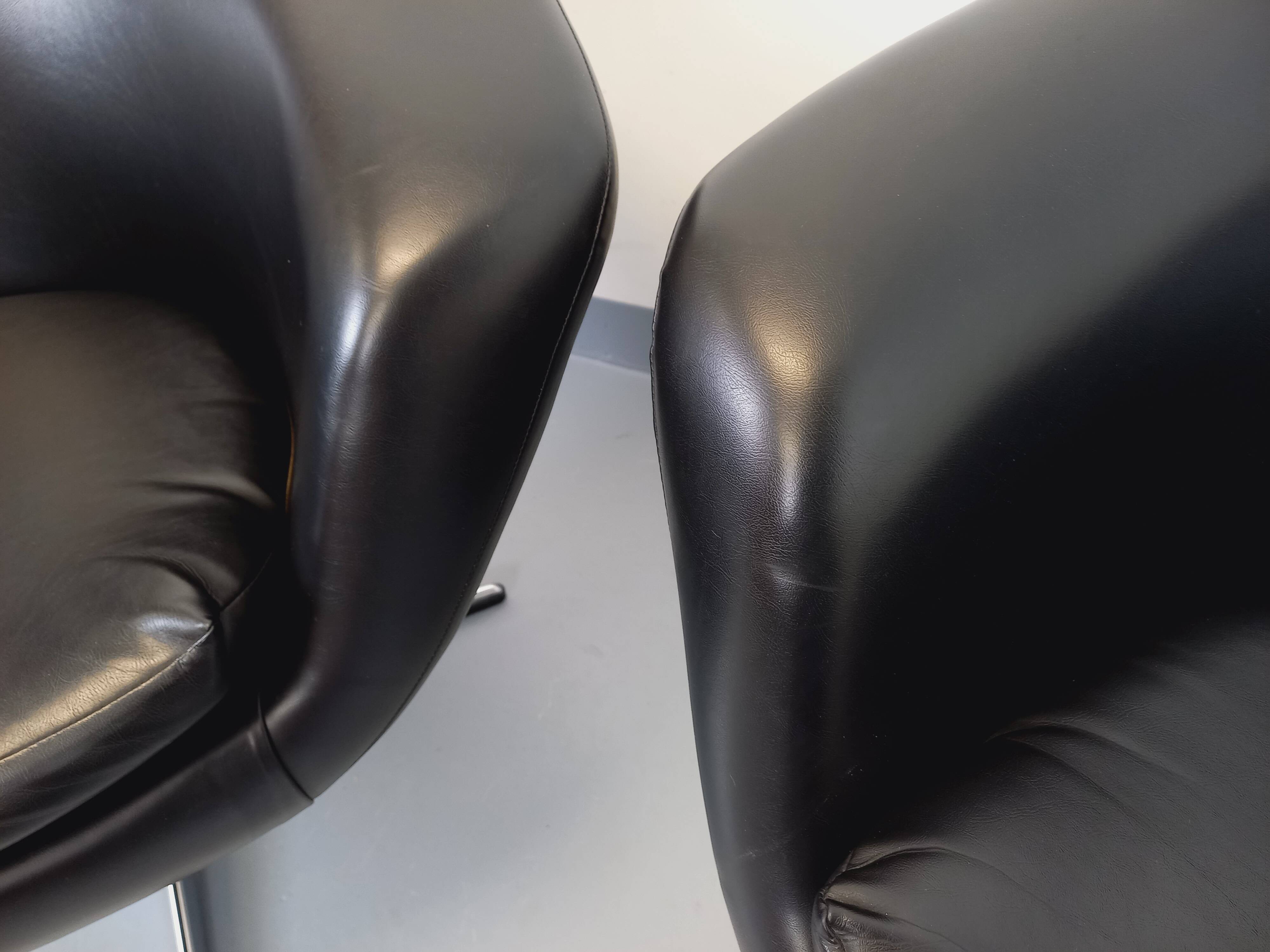 Pair of vintage Scandinavian swivel armchairs in faux leather and chrome.