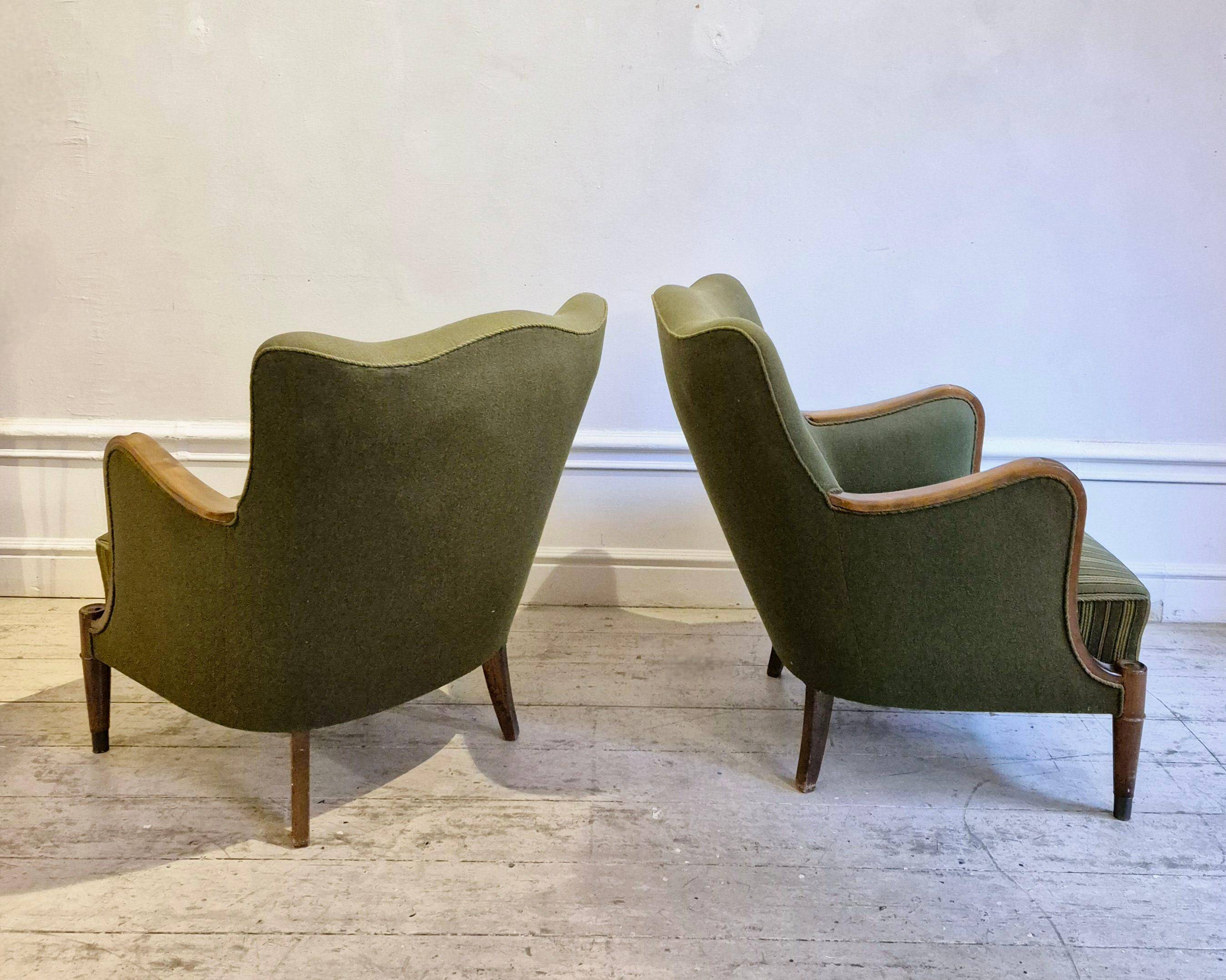Modern Danish armchairs by Alfred Christensen. Beautiful shape, brass legs.