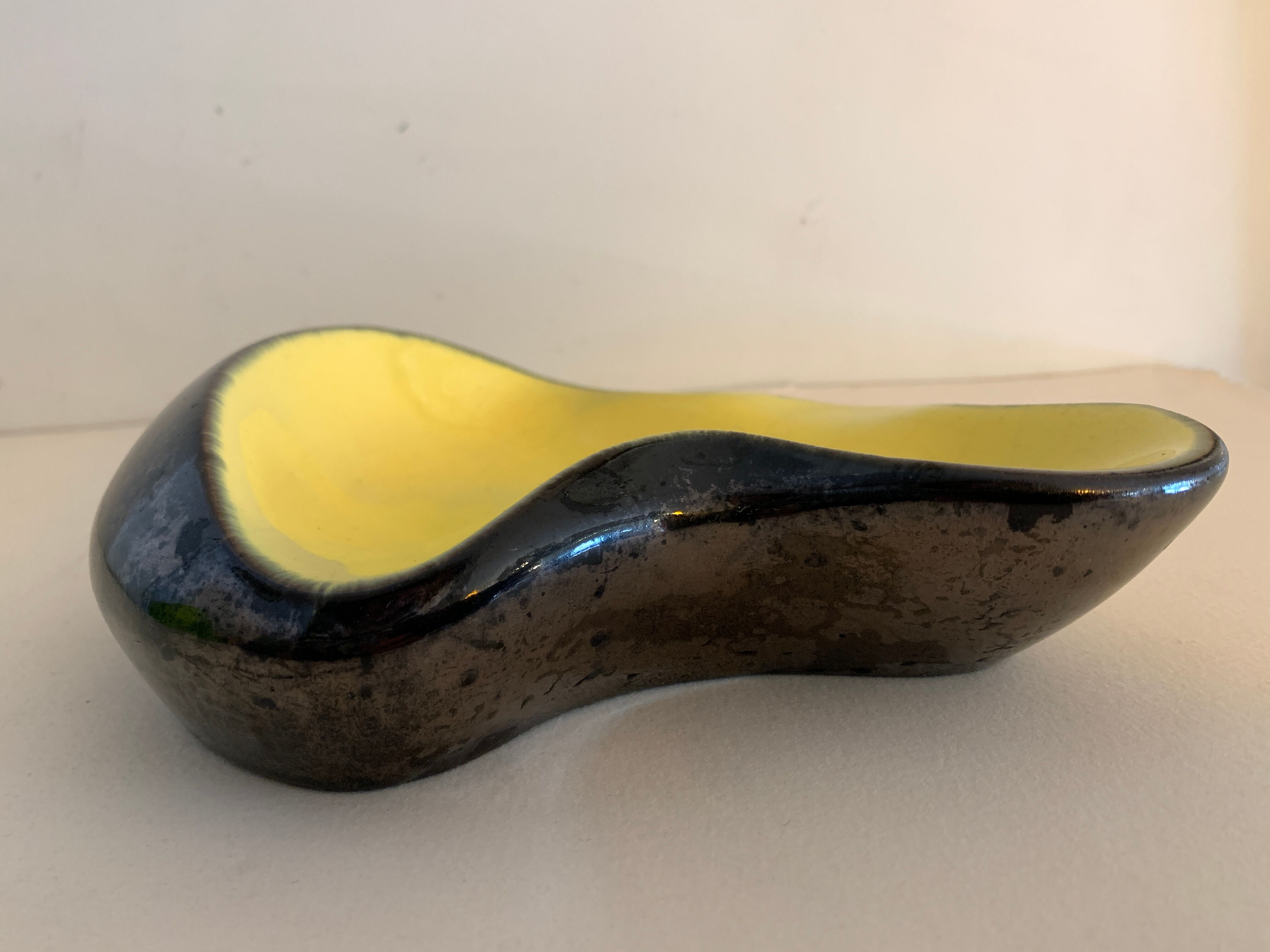Yellow and black ceramic ashtray