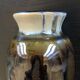 Brown and black flame-colored vase