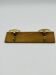 Vintage wall coat rack in brass and wood design.