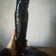 Black earthenware vase gloved hand