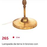 Bronze floor lamp with pine cone decoration.