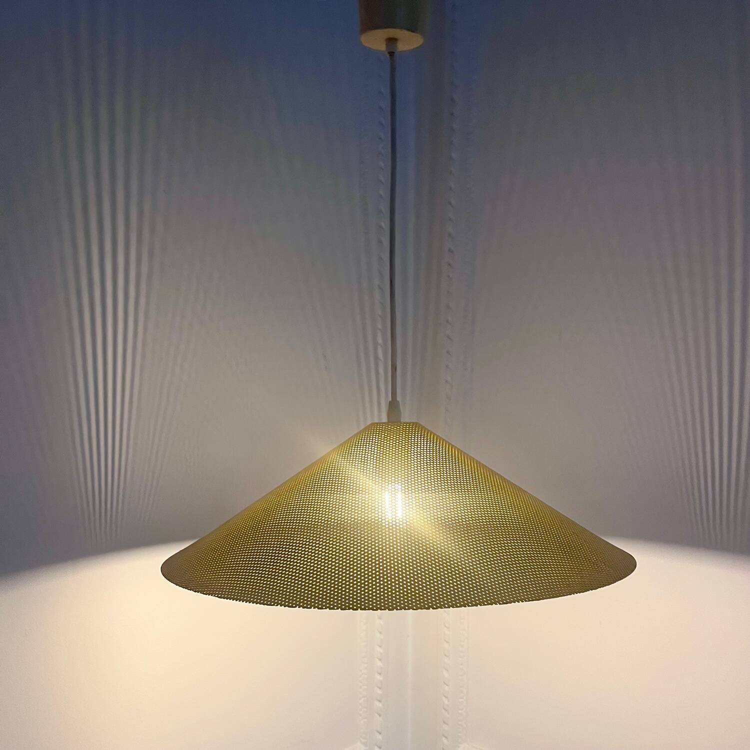 Yellow perforated sheet metal suspension