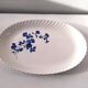 Keller and Guérin Lunéville serving dish with blue flowers on a white background.