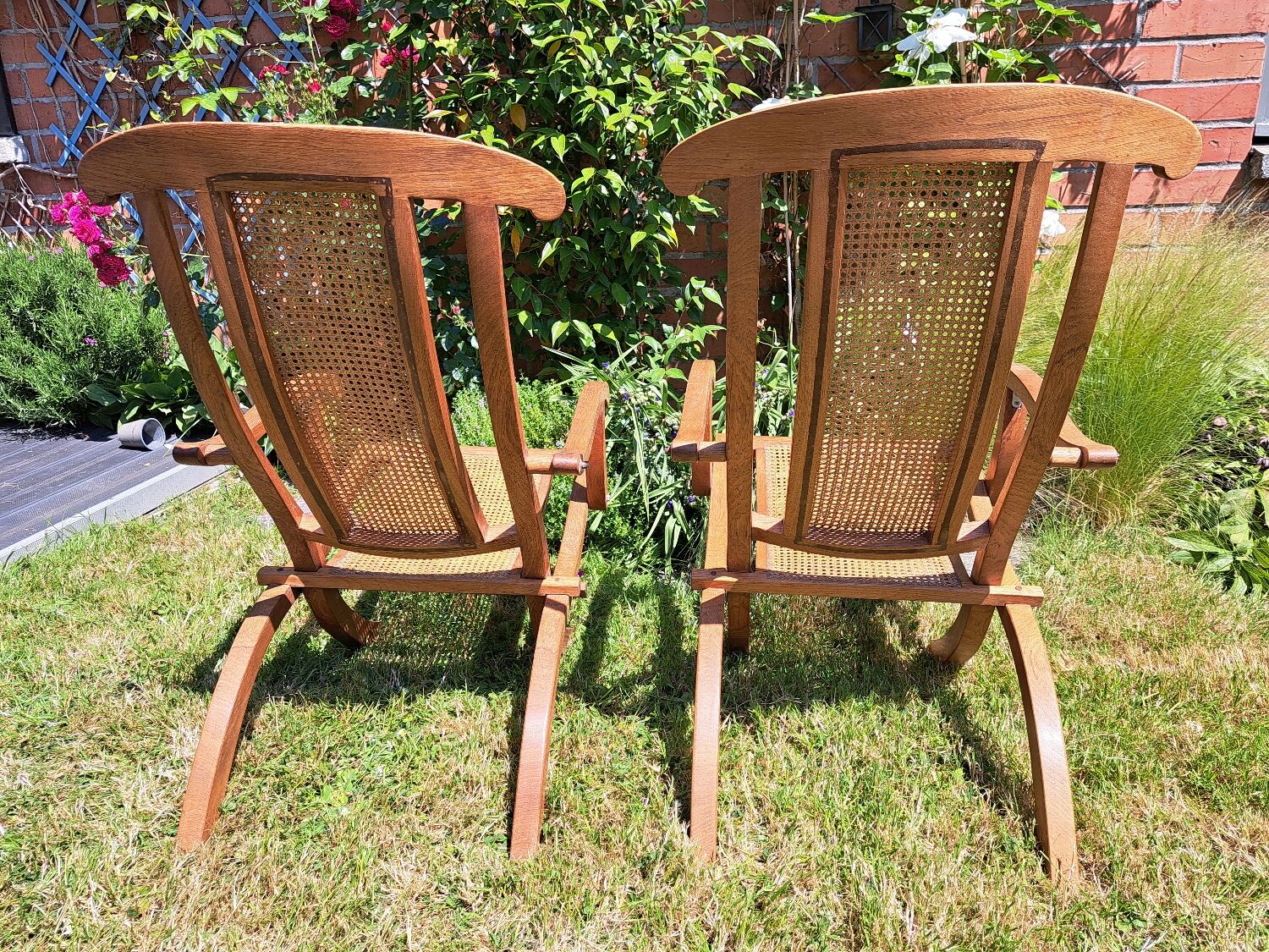 Pair of teak and cane deckchairs