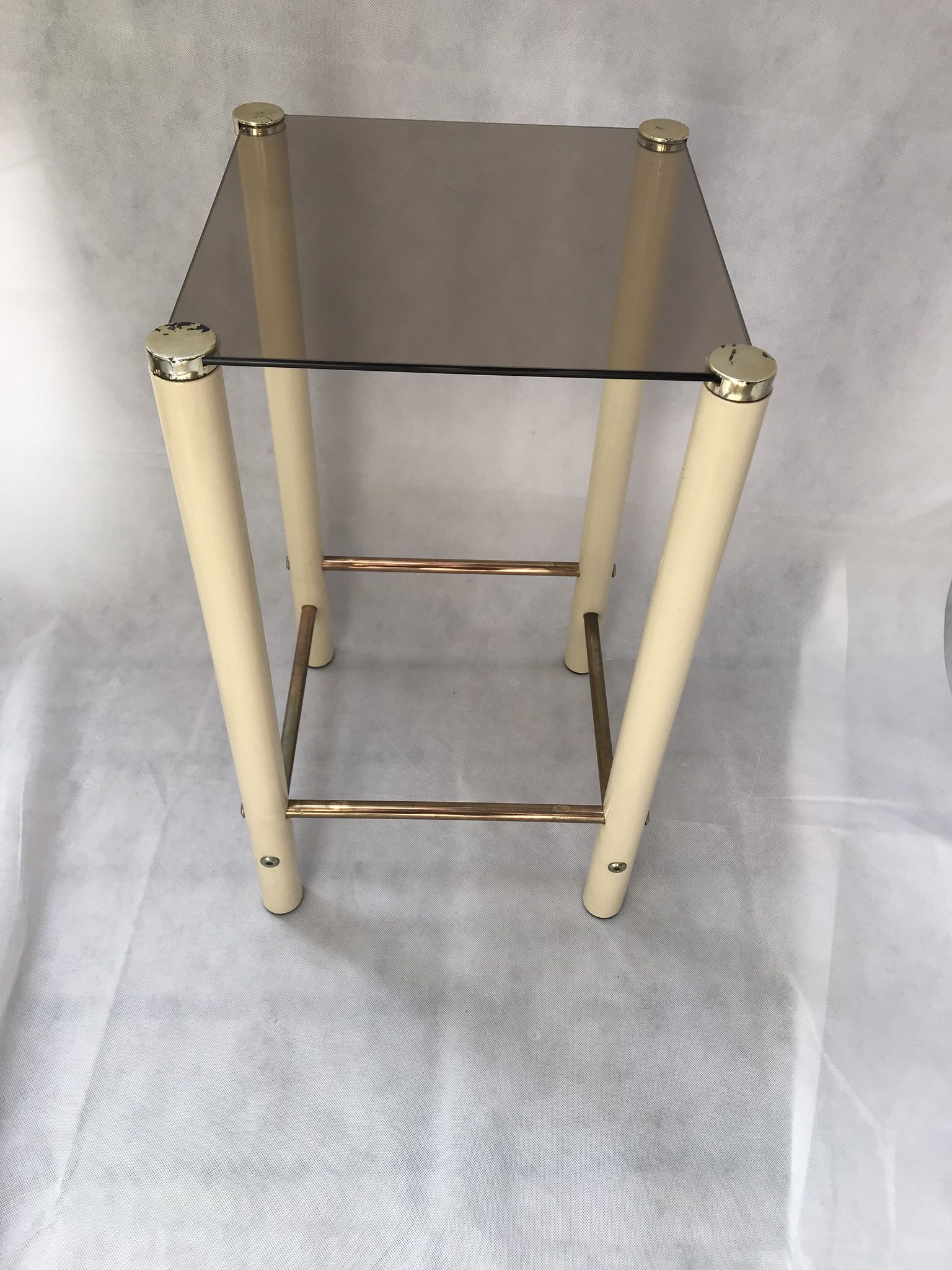 Square side table in metal and smoked glass.