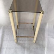 Square side table in metal and smoked glass.