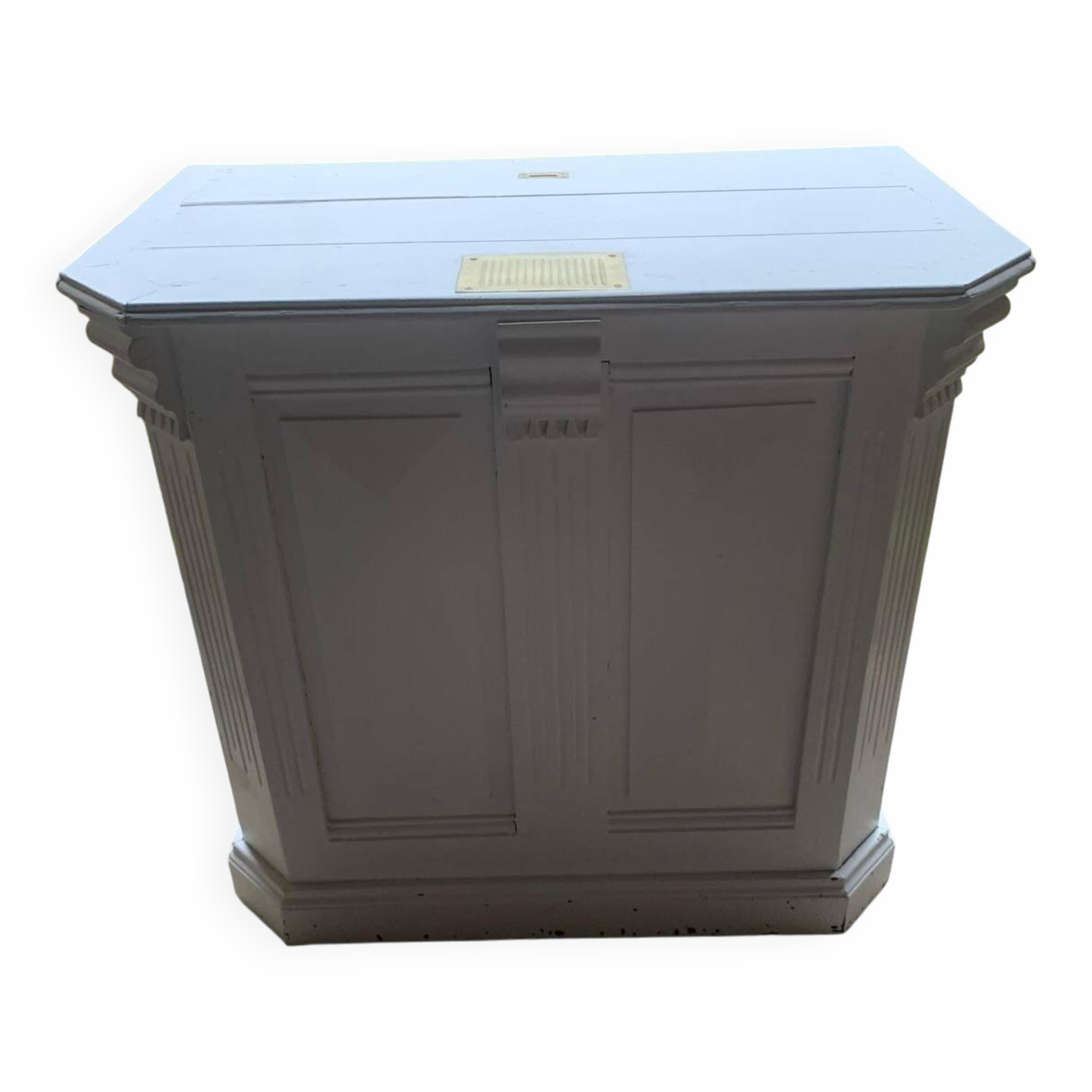 White counter with brass coin mechanism