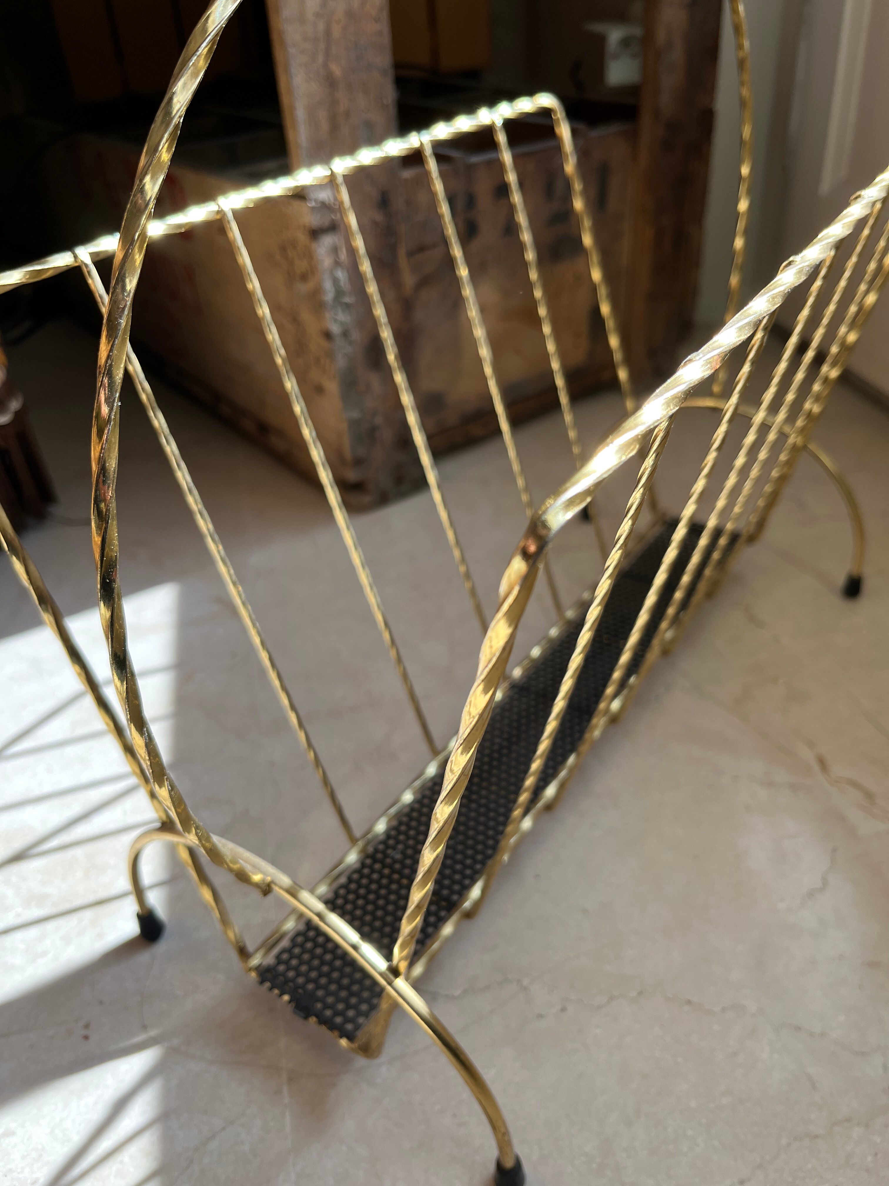 Vintage gold metal magazine rack from the 1960s.