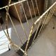 Vintage gold metal magazine rack from the 1960s.