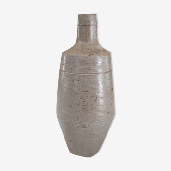 Bottle in speckled light brown sandstone