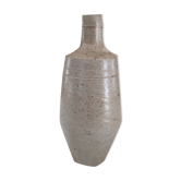 Bottle in speckled light brown sandstone