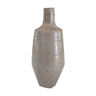 Bottle in speckled light brown sandstone