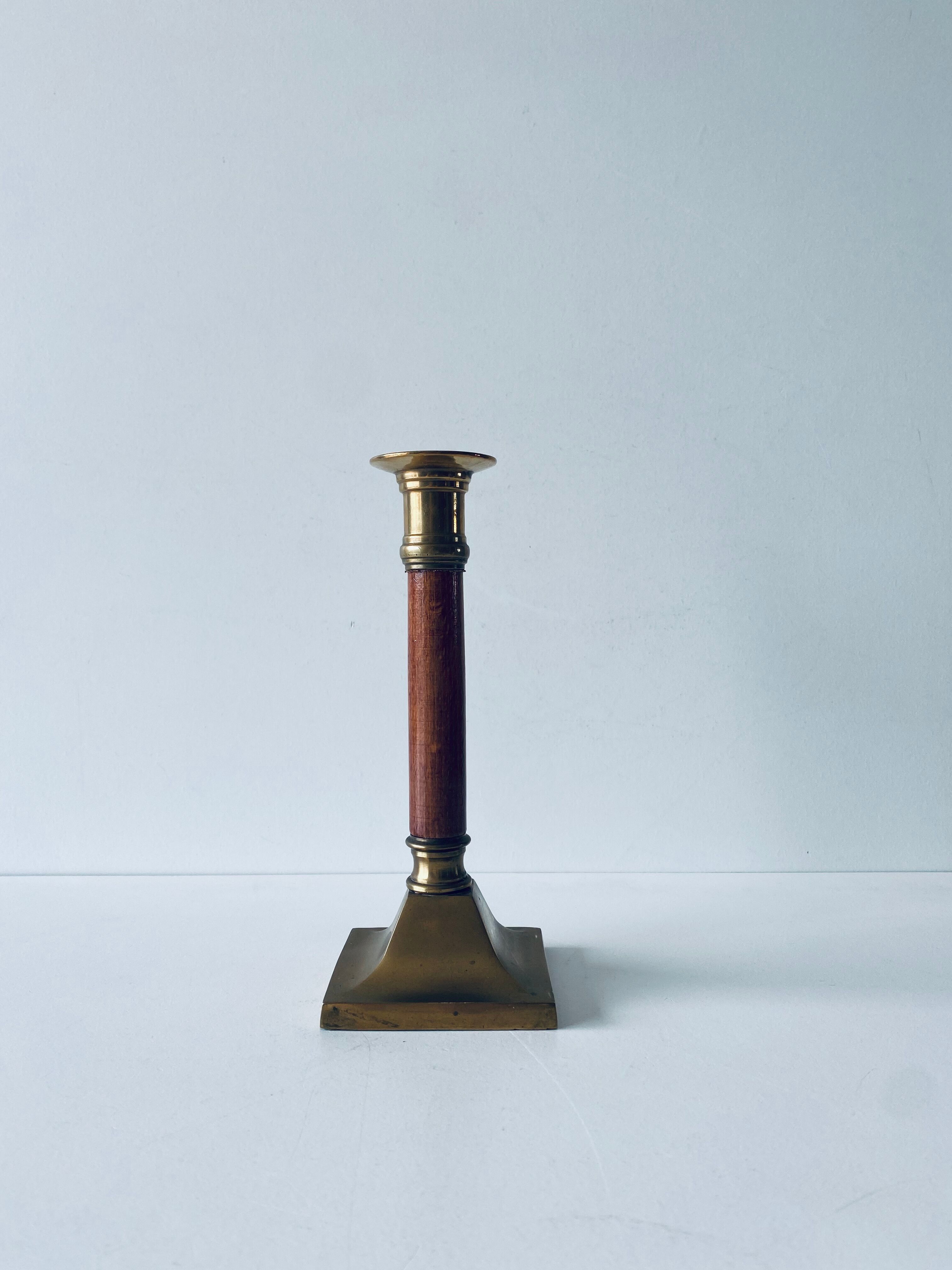 Old candle holder in brass and wood