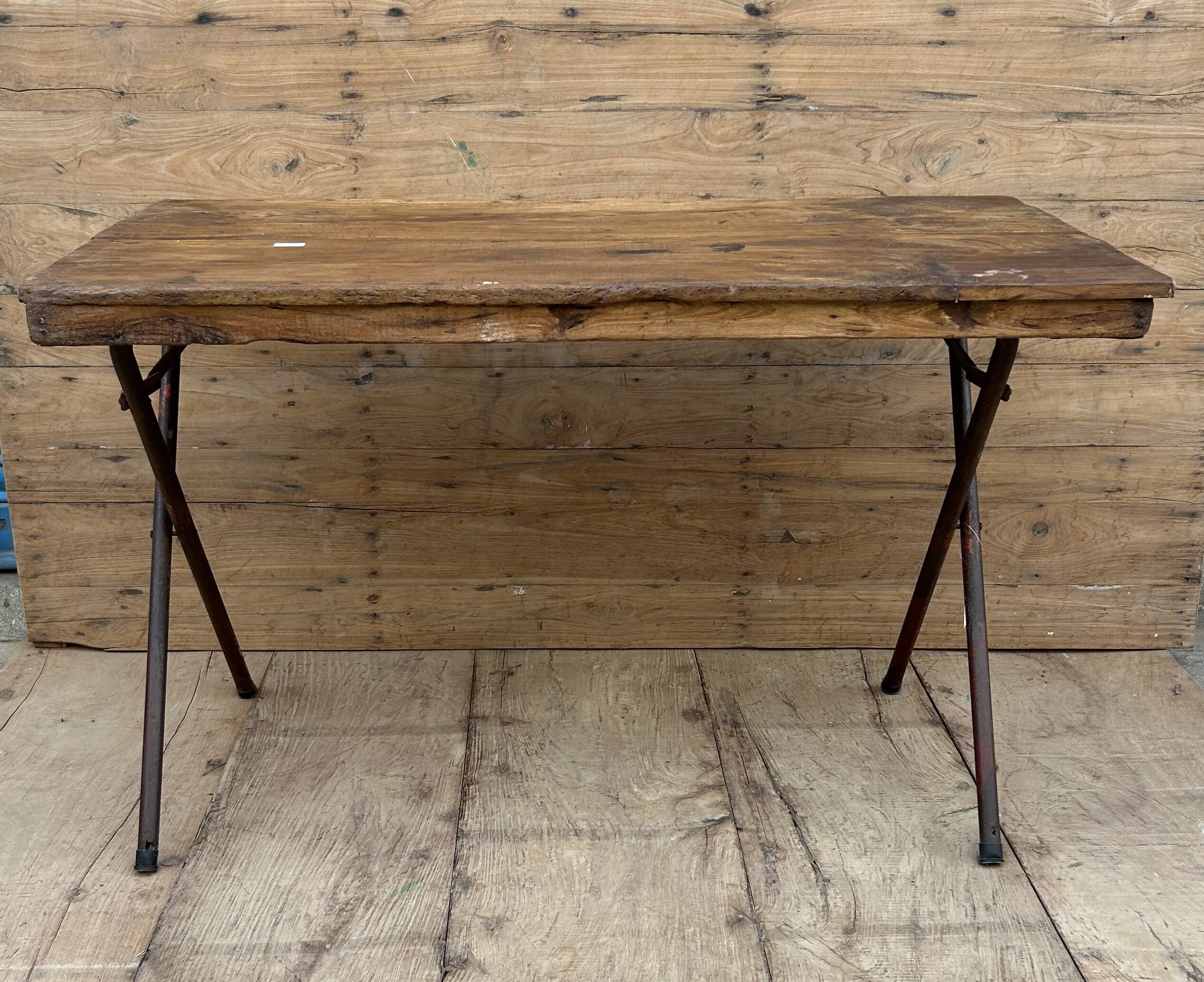 Folding workshop table with a metal frame and solid teak top.