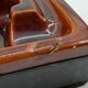 Geometric brown enamelled ashtray with a leather base (1960s-70s)