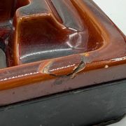 Geometric brown enamelled ashtray with a leather base (1960s-70s)