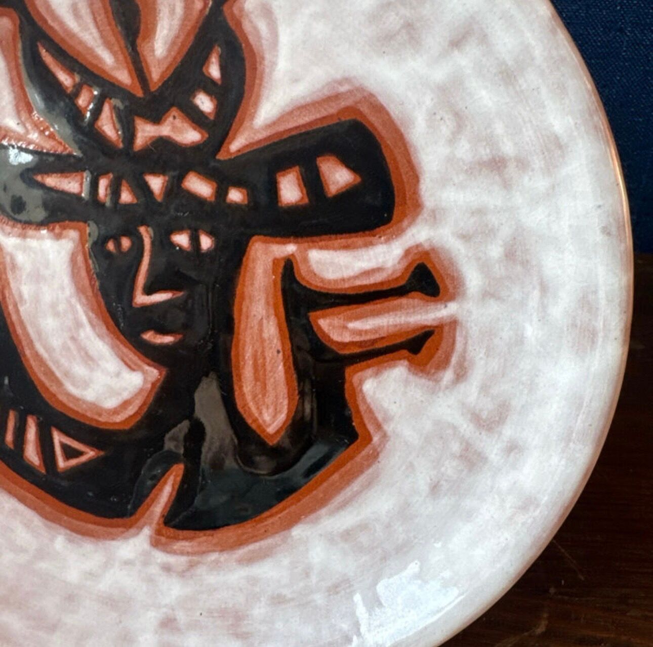 Terracotta plate, Jean Lurçat decorated with a character on a white background.