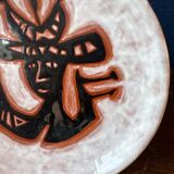 Terracotta plate, Jean Lurçat decorated with a character on a white background.