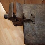 Small, very old, brutalist workbench equipped with a period workshop lamp