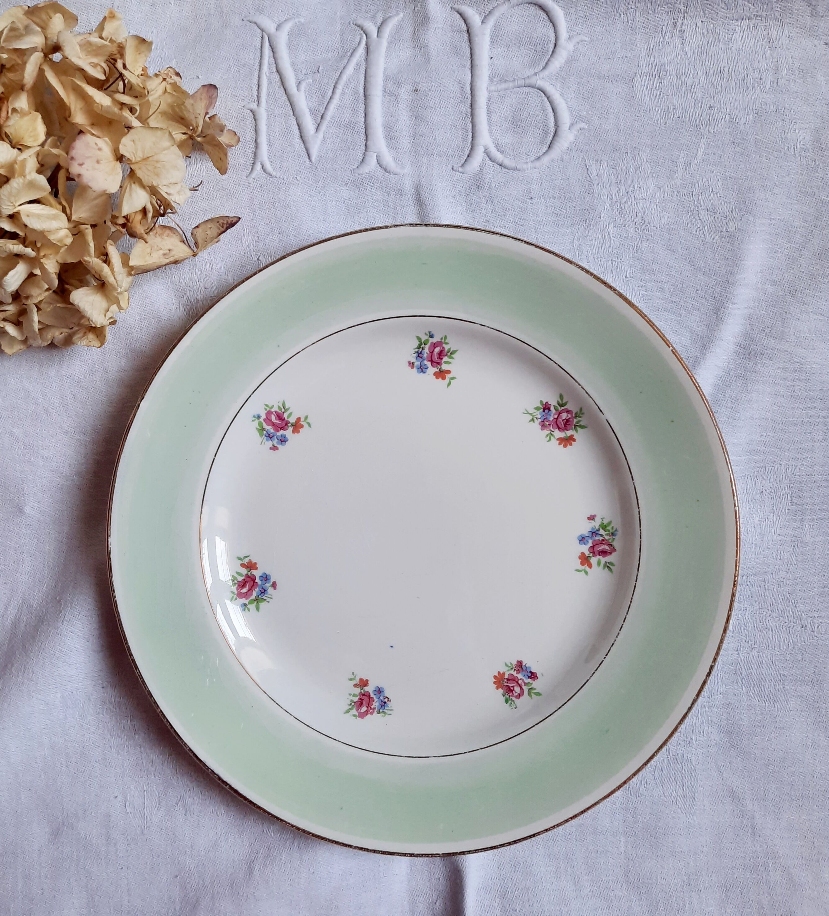 Flat antique earthenware plates with gilded edges