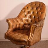 Office chair known as a presidential chair in mahogany and cognac leather.