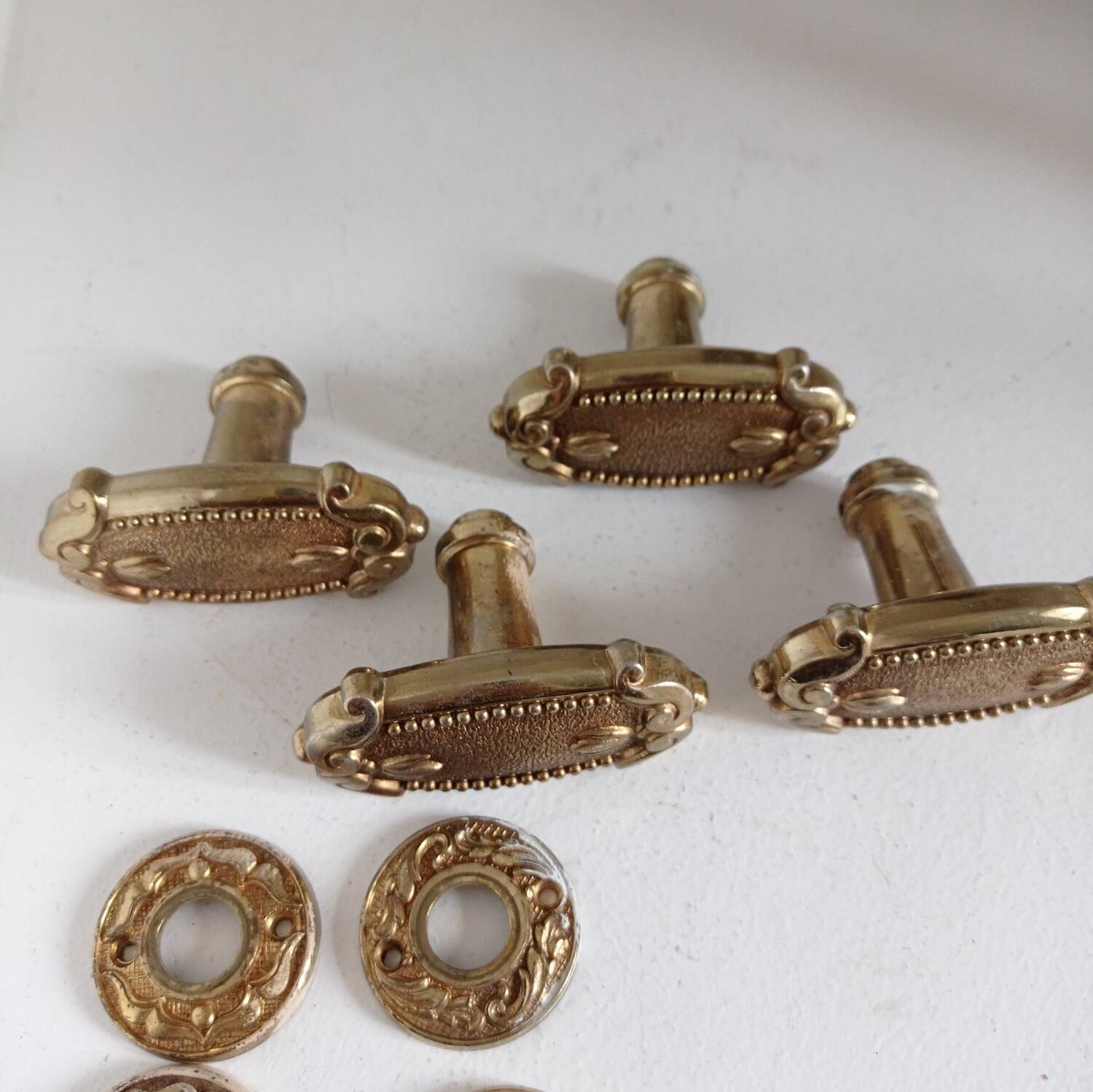 Gold door knobs and rosettes