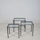 Set of nesting tables in black stained wood and glass top, 1960s